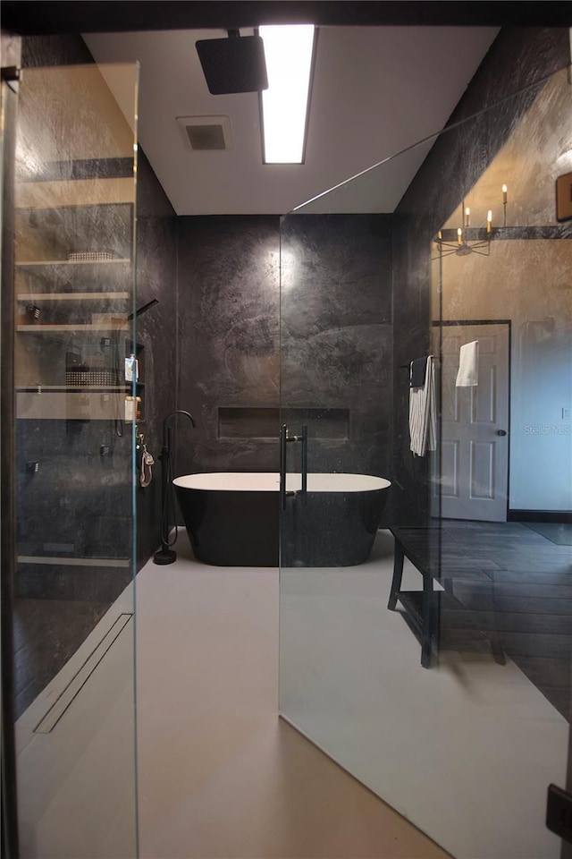 full bath featuring a soaking tub and visible vents