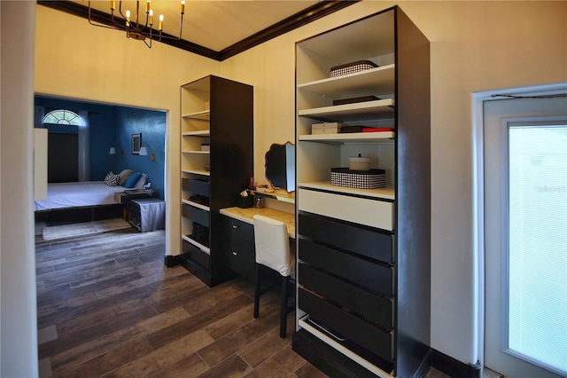 interior space featuring dark wood-style floors, ornamental molding, and a notable chandelier