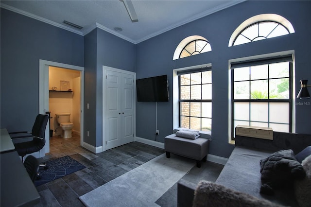 home office featuring ornamental molding, visible vents, plenty of natural light, and wood finished floors