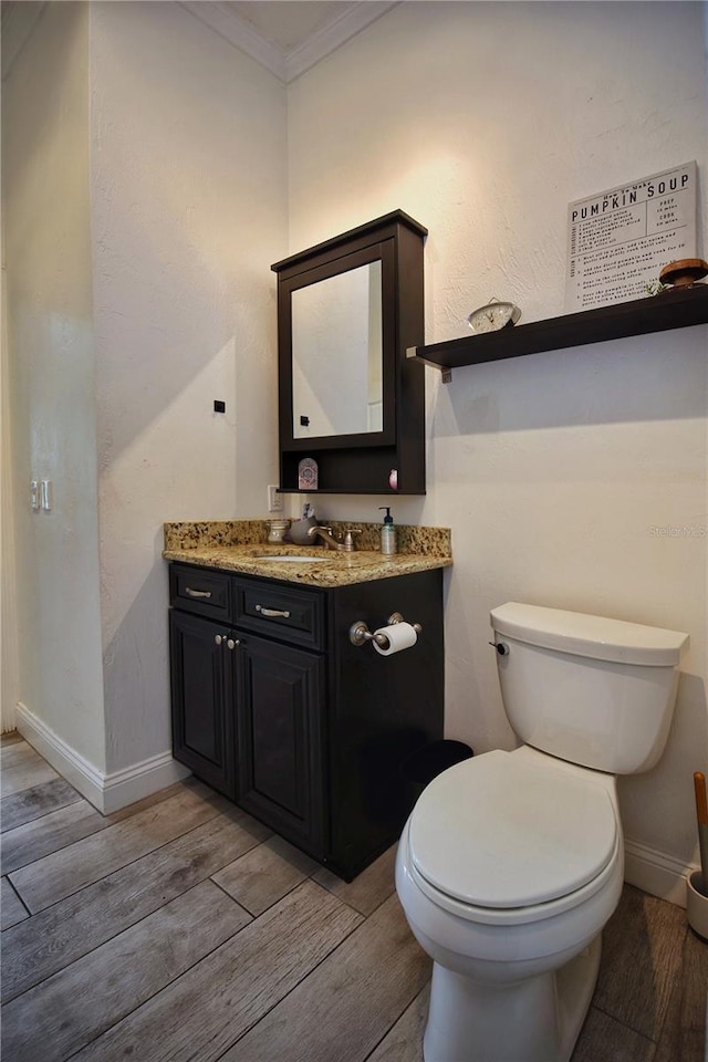 bathroom featuring crown molding, vanity, toilet, and wood tiled floor