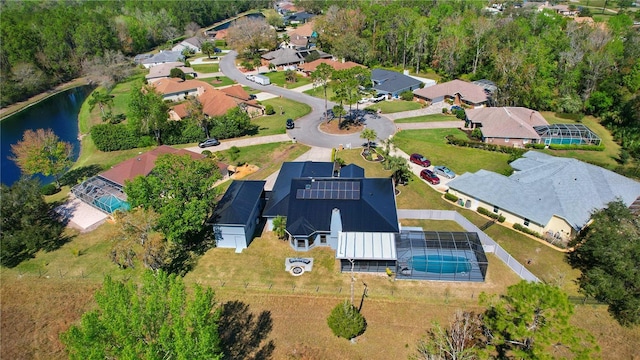 drone / aerial view featuring a water view and a residential view