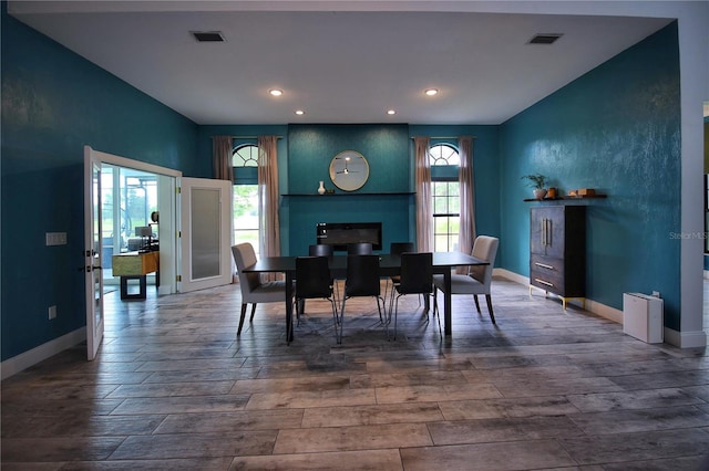 dining area with visible vents, baseboards, and wood finished floors