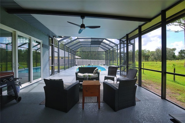 sunroom / solarium with ceiling fan and beamed ceiling