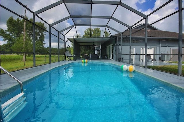 outdoor pool with a lanai, central AC, and a patio