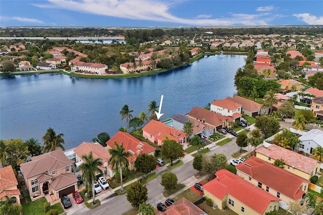 bird's eye view with a water view and a residential view