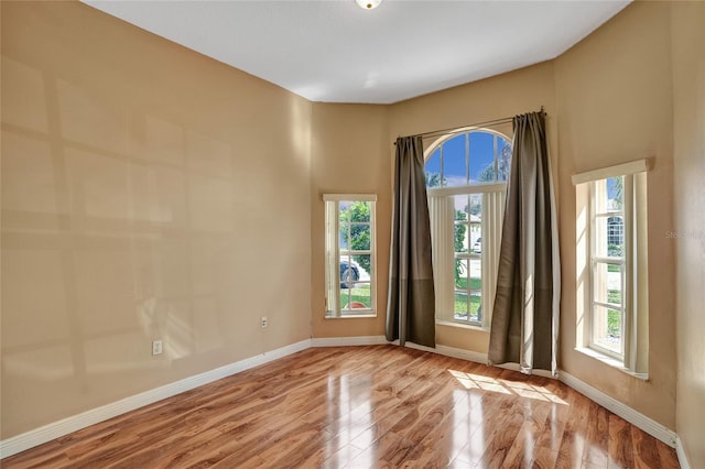 unfurnished room featuring wood finished floors and baseboards