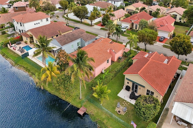 drone / aerial view featuring a water view and a residential view