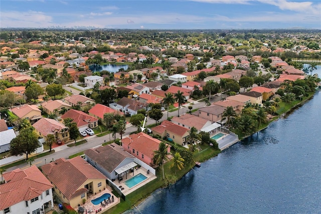 drone / aerial view with a water view and a residential view