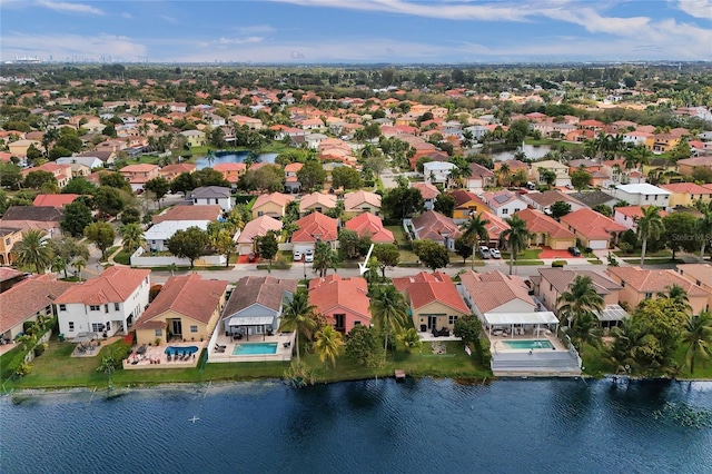 drone / aerial view with a water view and a residential view