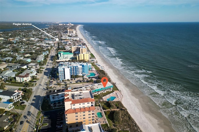 birds eye view of property with a water view and a view of the beach