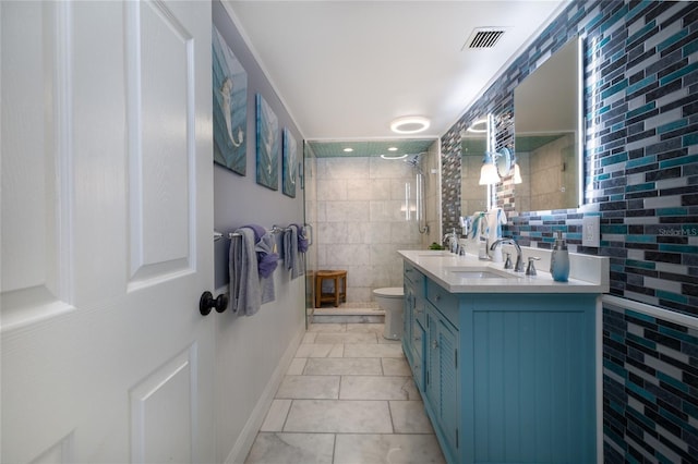 bathroom featuring double vanity, visible vents, toilet, a sink, and tiled shower