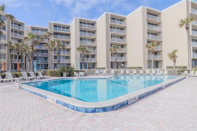 pool featuring a patio area and fence