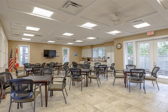 dining area featuring a ceiling fan, visible vents, a drop ceiling, and french doors