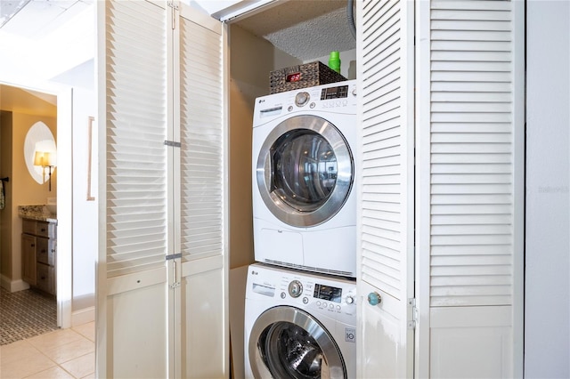 laundry room with light tile patterned floors, laundry area, and stacked washer / dryer