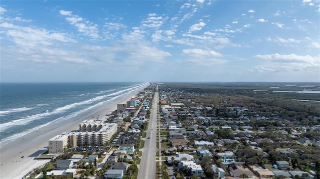 bird's eye view with a water view and a beach view