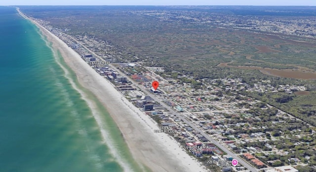 drone / aerial view with a water view and a beach view