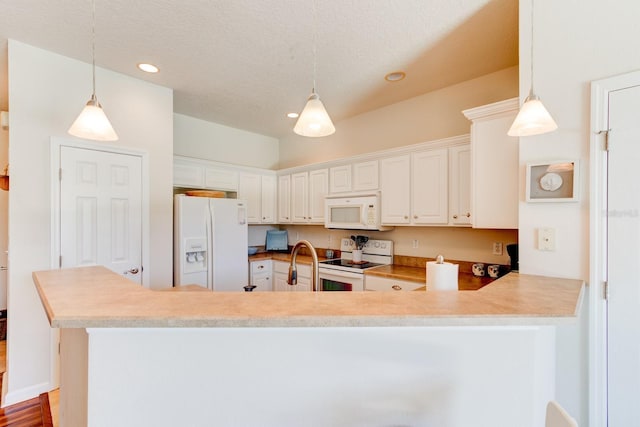 kitchen featuring white appliances, decorative light fixtures, a peninsula, white cabinetry, and recessed lighting