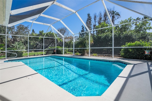 pool featuring a patio and glass enclosure