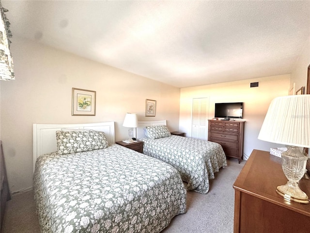 bedroom featuring a textured ceiling, a closet, and carpet