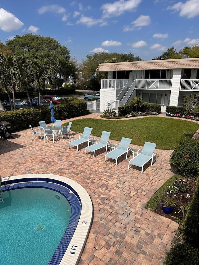 view of swimming pool featuring a pool, a patio area, and a yard