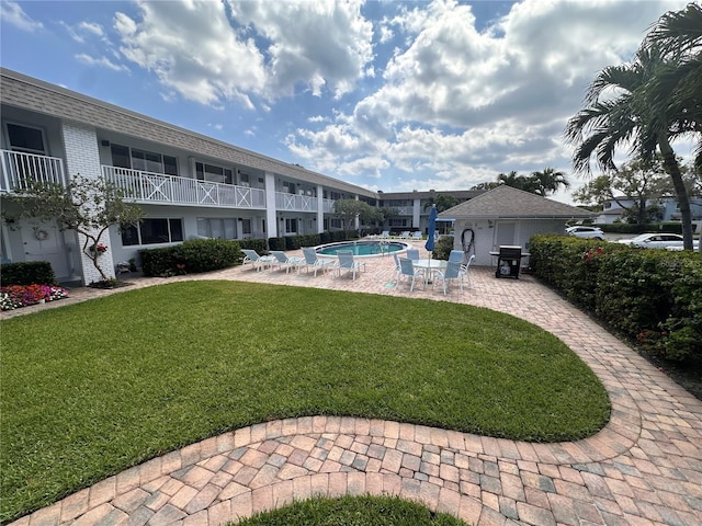 view of yard featuring a patio and a community pool