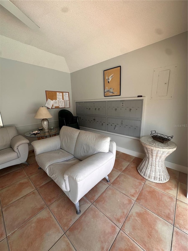 tiled bedroom with lofted ceiling, electric panel, baseboards, and a textured ceiling