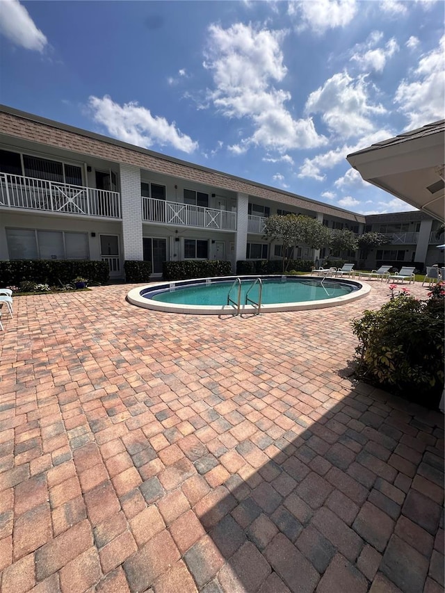 community pool featuring a patio area