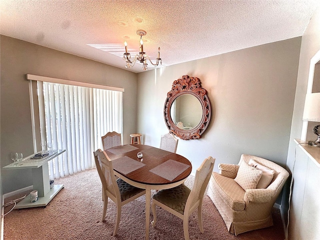 carpeted dining room with a textured ceiling and an inviting chandelier