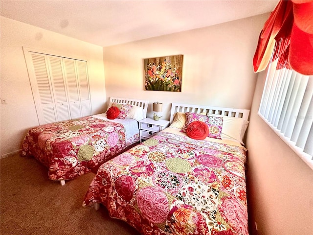 bedroom with carpet and a closet