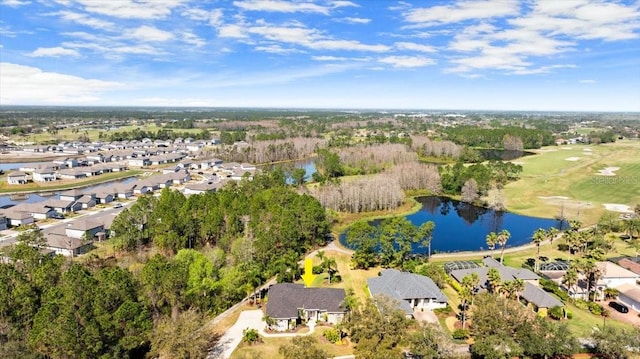 drone / aerial view with a water view, a residential view, and a view of trees