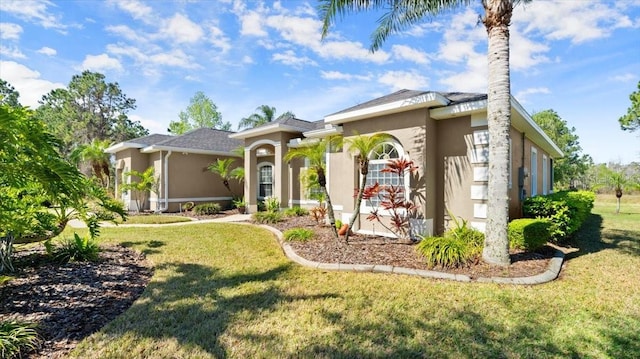 mediterranean / spanish home with a front lawn and stucco siding