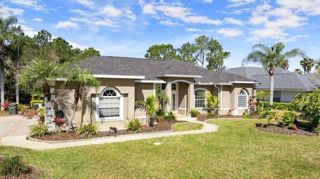 single story home featuring a front lawn, a shingled roof, and stucco siding