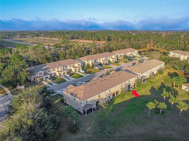 drone / aerial view with a residential view and a view of trees