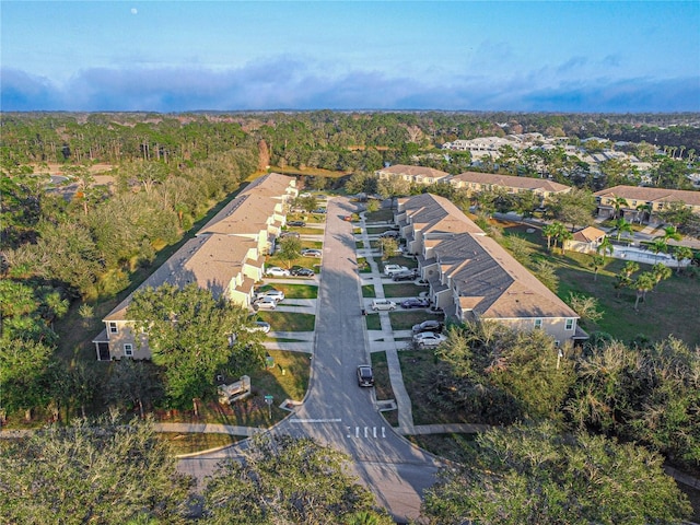 birds eye view of property featuring a residential view and a forest view