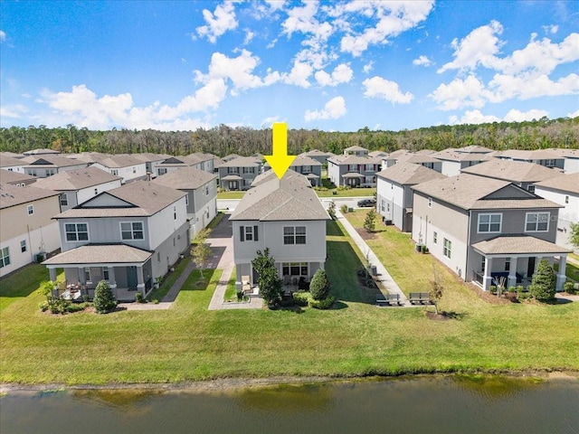 birds eye view of property with a residential view and a water view