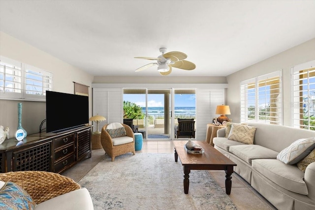 tiled living room featuring a ceiling fan