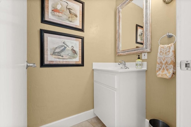 bathroom with tile patterned flooring, baseboards, and vanity