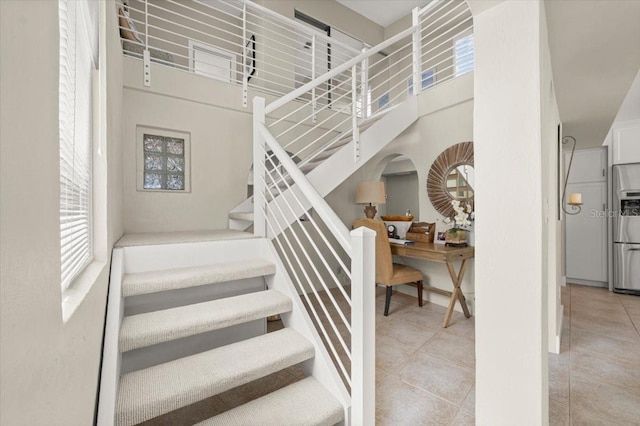 staircase featuring tile patterned floors