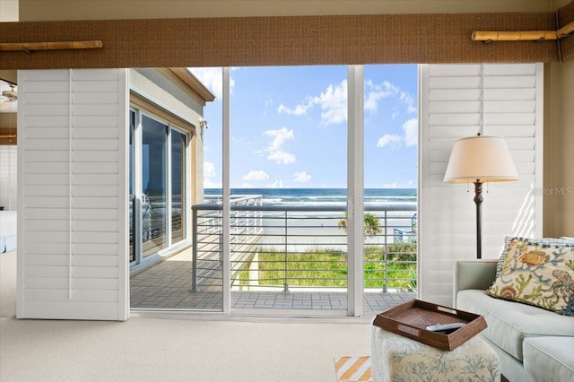 living room with carpet floors and a water view