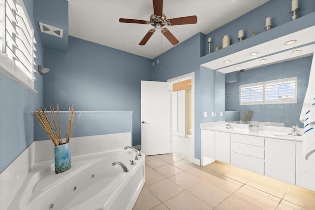 full bath with double vanity, a jetted tub, a sink, and visible vents