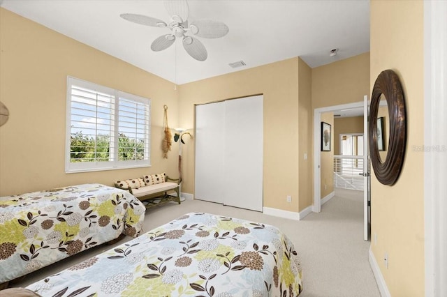 bedroom featuring baseboards, visible vents, ceiling fan, carpet flooring, and a closet