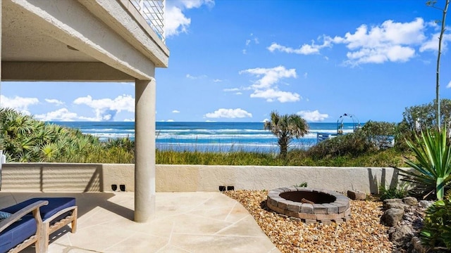 view of patio / terrace with a water view and a fire pit