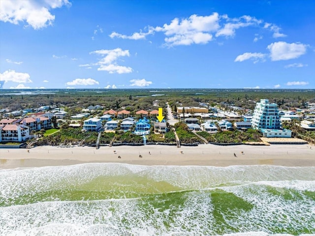 aerial view with a view of the beach, a water view, and a residential view