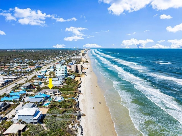 drone / aerial view featuring a water view and a beach view