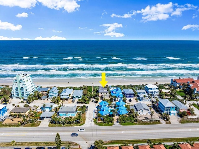 drone / aerial view with a water view and a view of the beach