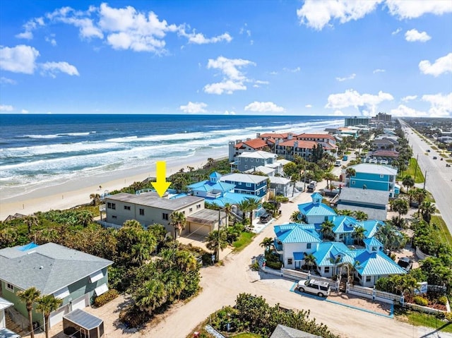 drone / aerial view featuring a water view and a view of the beach