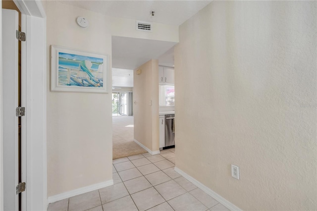 407 Bouchelle Dr Unit 205, New Smyrna Beach, FL 32169 - hallway featuring visible vents, light carpet, baseboards, and light tile patterned flooring