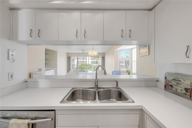 407 Bouchelle Dr Unit 205, New Smyrna Beach, FL 32169 - kitchen with dishwasher, light countertops, a sink, and white cabinets