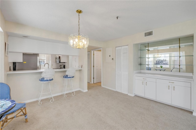407 Bouchelle Dr Unit 205, New Smyrna Beach, FL 32169 - kitchen featuring stainless steel appliances, light colored carpet, visible vents, and baseboards
