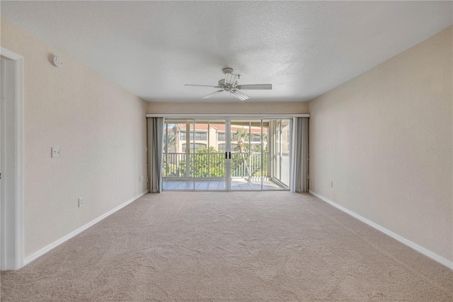 407 Bouchelle Dr Unit 205, New Smyrna Beach, FL 32169 - carpeted empty room featuring a ceiling fan, a textured ceiling, and baseboards